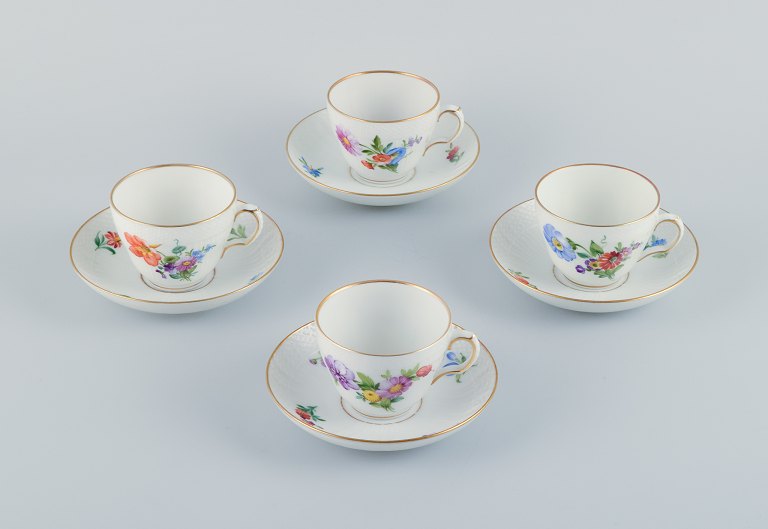 Royal Copenhagen, Saxon Flower, a set of four coffee cups with saucers, 
hand-decorated with polychrome flowers and gold rim.