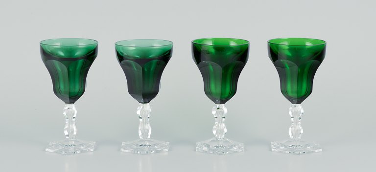 Val St. Lambert, Belgium, a set of four "Lalaing" white wine glasses in green 
faceted cut crystal glass.