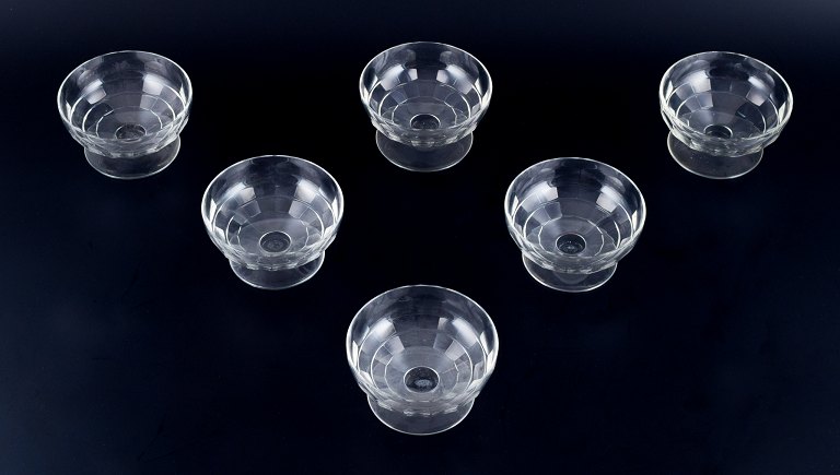 Baccarat, France, a set of six "Charmes" Art Deco champagne coupes in clear 
crystal glass. Faceted cut.