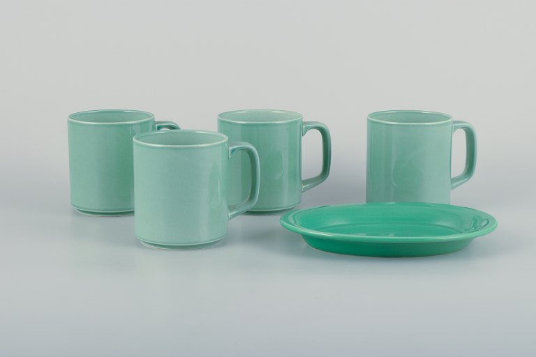 Royal Copenhagen, 4 All Seasons, four coffee mugs and a small oval dish in 
faience with green glaze.