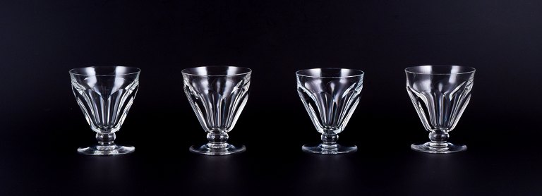 Baccarat, France. A set of four Art Deco red wine glasses in faceted crystal 
glass.