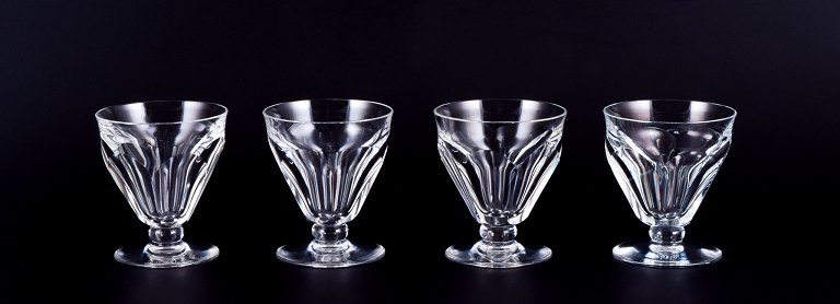 Baccarat, France. A set of four Art Deco white wine glasses in faceted crystal 
glass.
