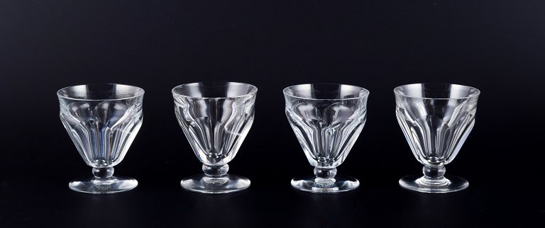 Baccarat, France. A set of four Art Deco white wine glasses in faceted cut 
crystal glass.