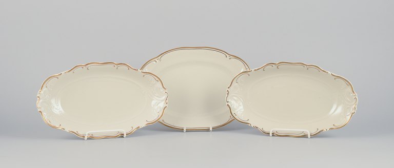 KPM, Poland. Three oblong porcelain platters.
Cream-colored with gold rim decoration.