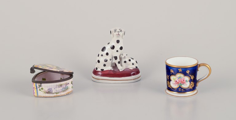 Three pieces of French and English porcelain including a Royal Crown Derby 
miniature cup, a miniature porcelain figurine of two Dalmatians, and a JACQUES 
FEBVRIER Manufactory signed "LILLE, 1763" Small Faience box.