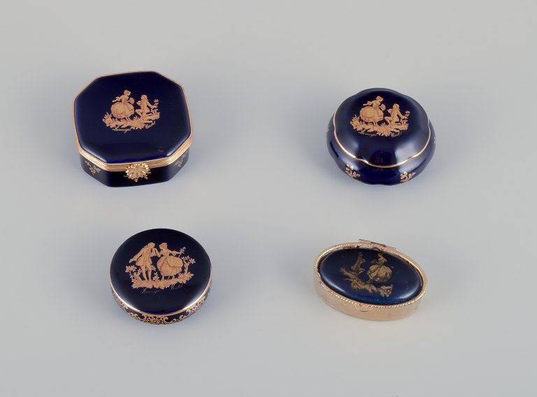 Limoges, France. Four lidded porcelain boxes, two with brass mounts, decorated 
with 22-karat gold leaf and a beautiful royal blue glaze. Scène galante.
