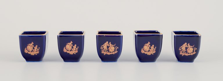 Limoges, France. Five miniature porcelain vases decorated with 22-karat gold 
leaf and beautiful royal blue glaze. Scène galante.