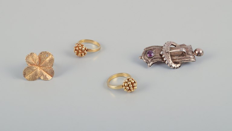 Flora Danica jewelry and more. Three Flora Danica finger rings in gilded 
sterling silver and a silver brooch adorned with violet semi-precious stones.