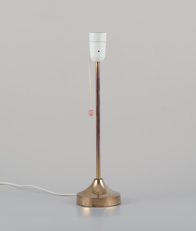 Nybro Armaturfabrik, Sweden. Brass table lamp.
Sleek Scandinavian design with wooden toggle switch.