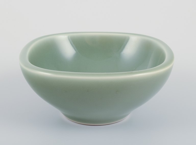 Nils Thorsson for Royal Copenhagen. Ceramic bowl in celadon glaze. Featuring a 
fish motif.