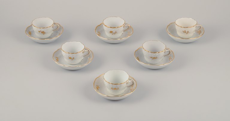 Meissen, Germany.
Six-person coffee set in porcelain consisting of six cups and six saucers. 
Hand-decorated in gold with flowers in a classic style.