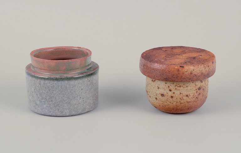 European studio potter. 
Two unique ceramic jars, one with a lid. Glazed in earth tones and blue-gray 
hues.