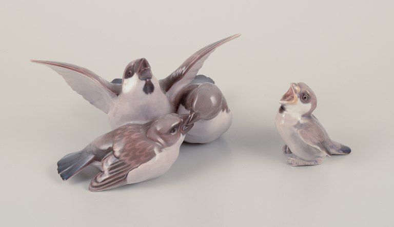 Bing & Grøndahl, Denmark.
Two porcelain figurines consisting of a group of three sparrows and sparrow 
chick.