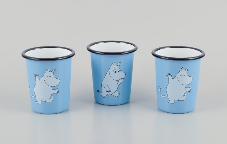 Muurla, Finland.
Three enamel mugs featuring motifs of Moomin trolls.