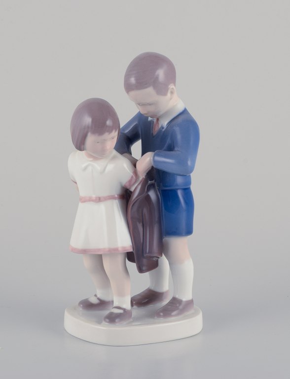 Bing and Grondahl, porcelain figurine - Boy helps girl with her jacket.