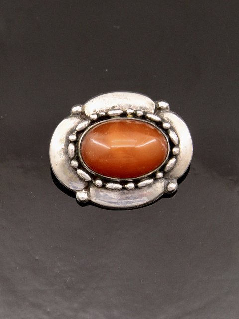 Silver brooch with amber