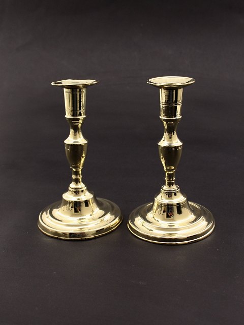 A pair of empire brass candlesticks