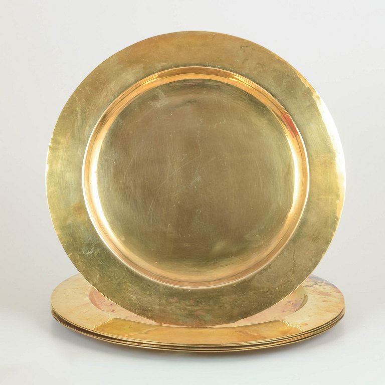 Scandinavian design, set of six brass charger plates.