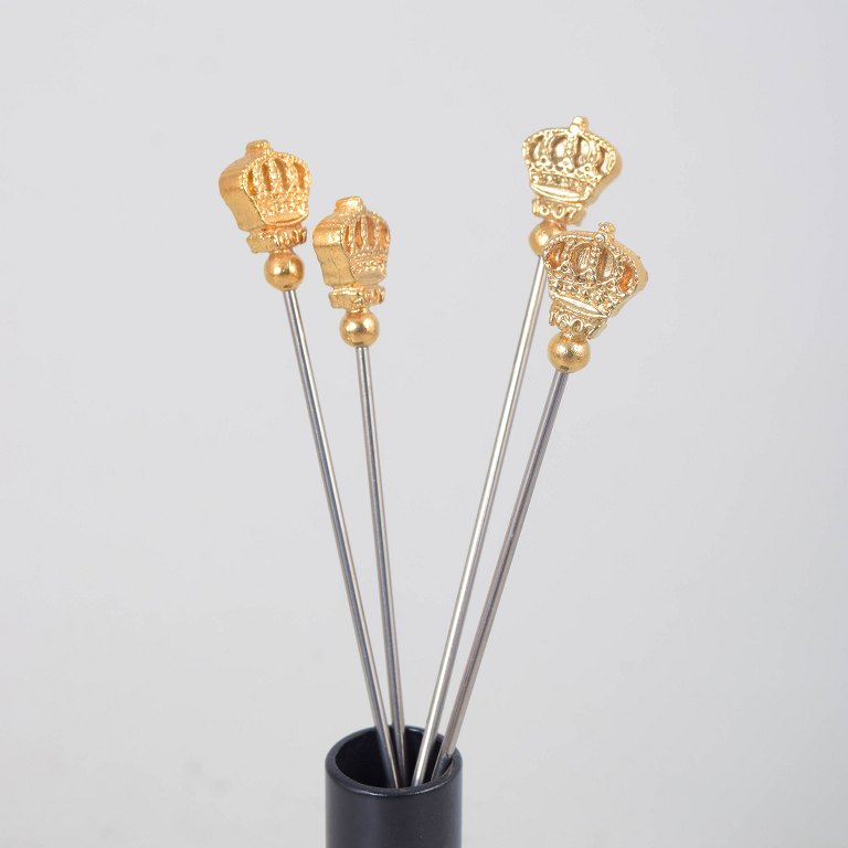 Skultuna, set of four cocktail sticks with crown motif.